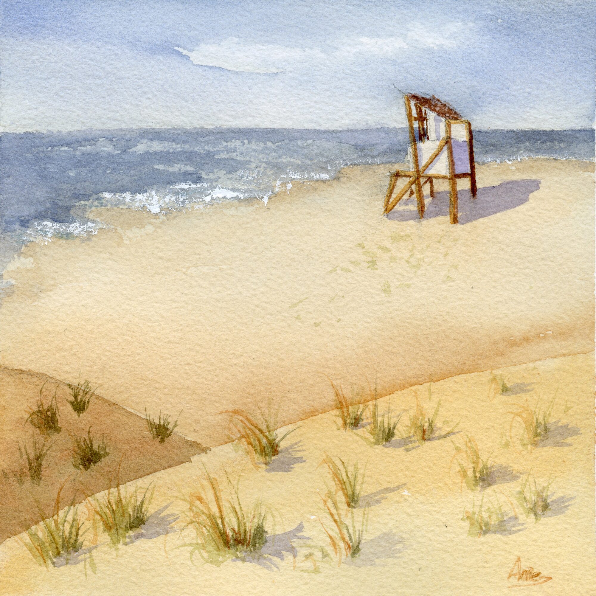 a wooden lifeguard tower standing alone on a wide sandy beach, with dune grass in the foreground and a calm blue sea beyond